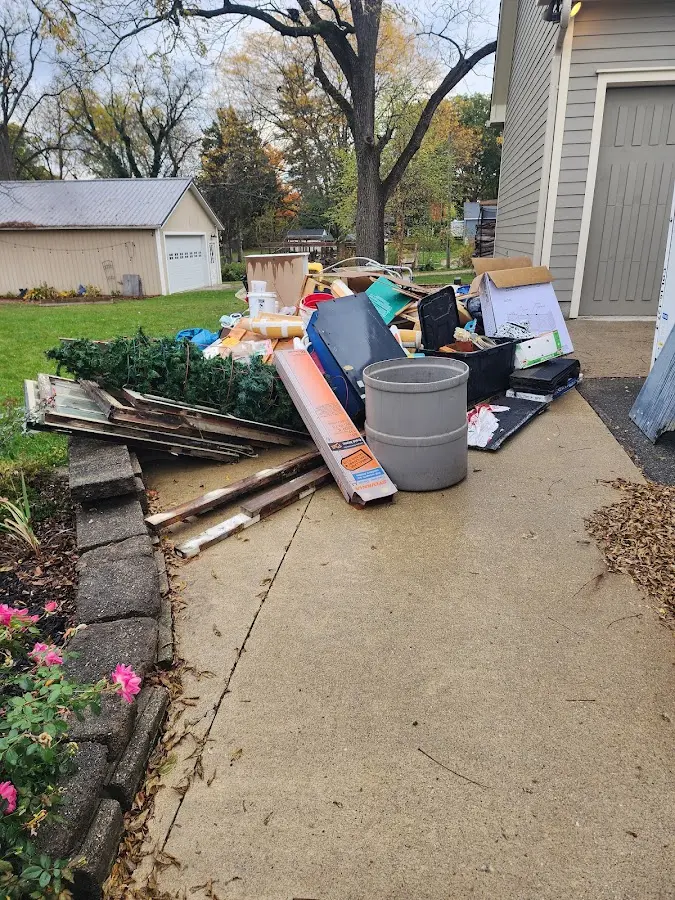 Dumpster being loaded with debris for 30 Yard Dumpster Rental in Lowell